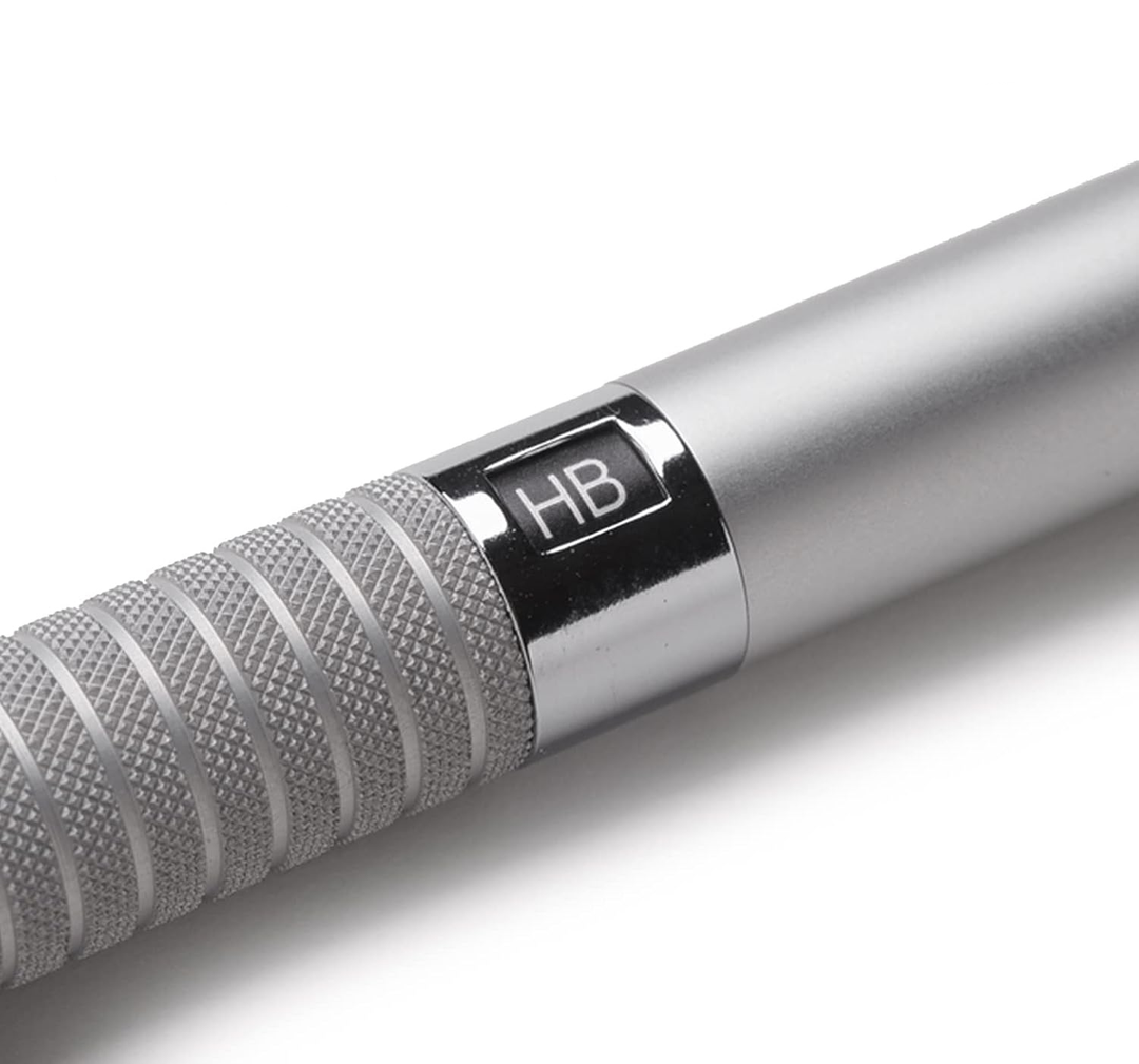 Macro shot of Staedtler 925 25 diamond-cut knurled grip and adjustable lead hardness indicator. High-rigidity aluminum construction for non-slip control.