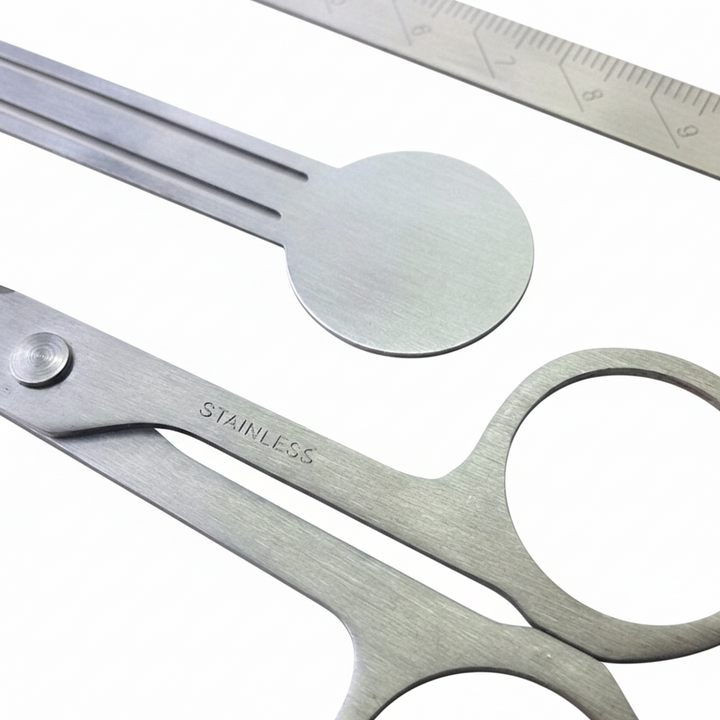 Close-up detail of the V-ROAD Ultra-Thin Stationery Set, focusing on the circular head of the bookmark clip and the engraved measurement markings on the stainless steel ruler.