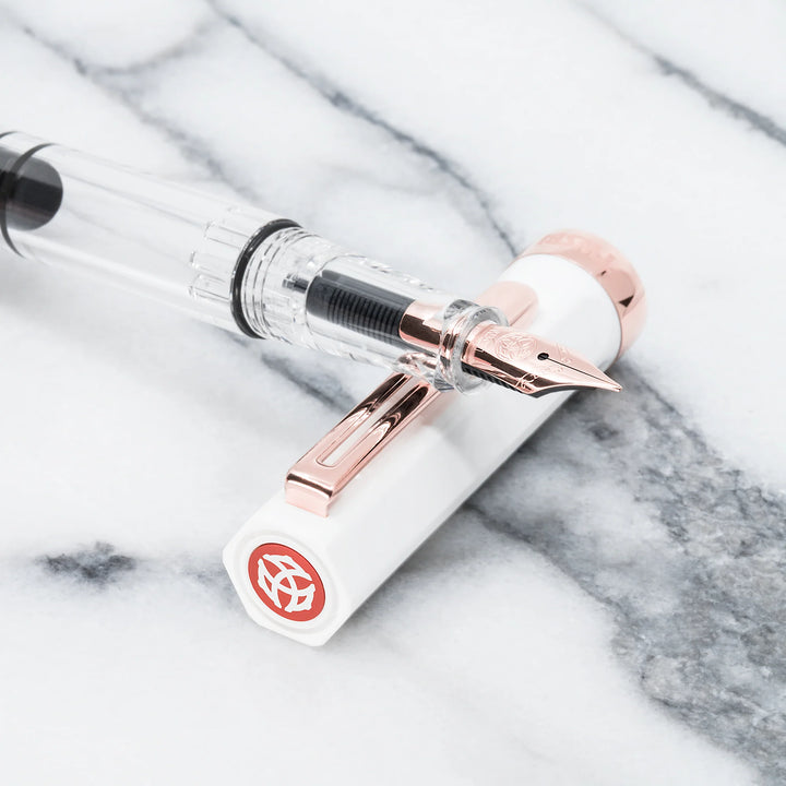 TWSBI ECO Fountain Pen – White Rose Gold with rose gold accents on a marble surface