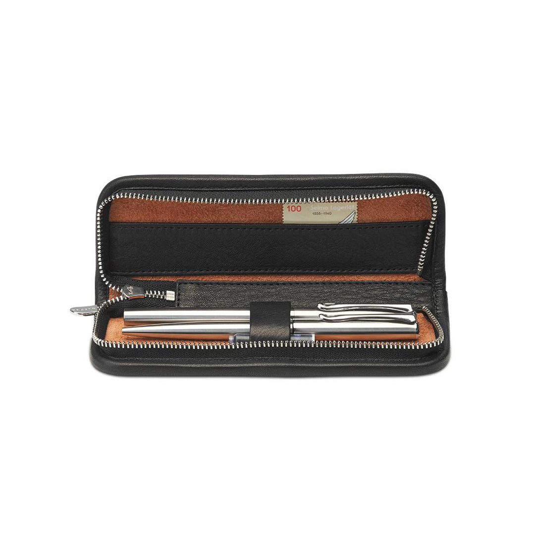 Interior of Black Sonnenleder Grass Leather Pen Case featuring 3 leather-covered loops holding silver pens and a tan leather accessory compartment.